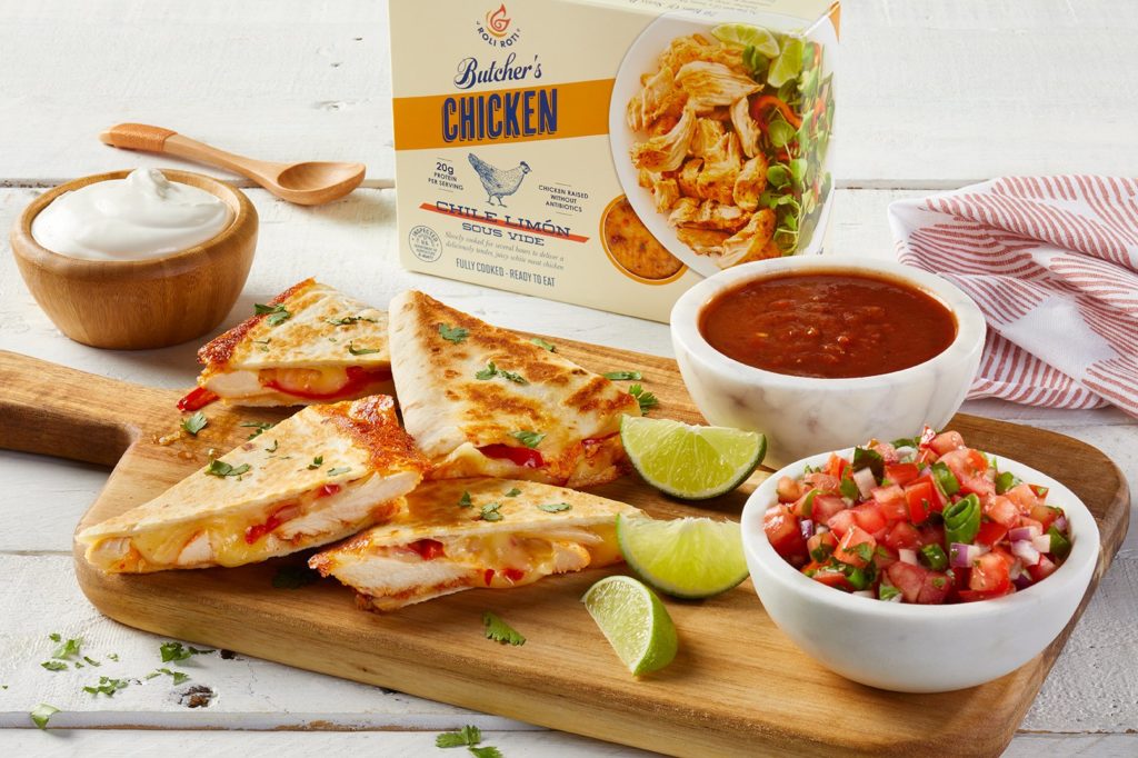 Chile Limón Chicken & Red Pepper Quesadillas on a cutting board with salsa and limes